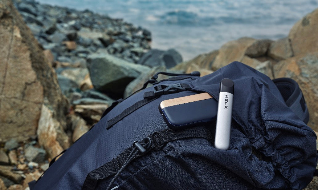 person holding blue relx vape device